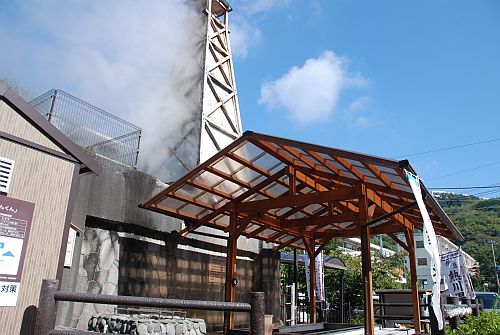 温泉やぐらと温泉の湯気が立ち込める屋根付き足湯の写真